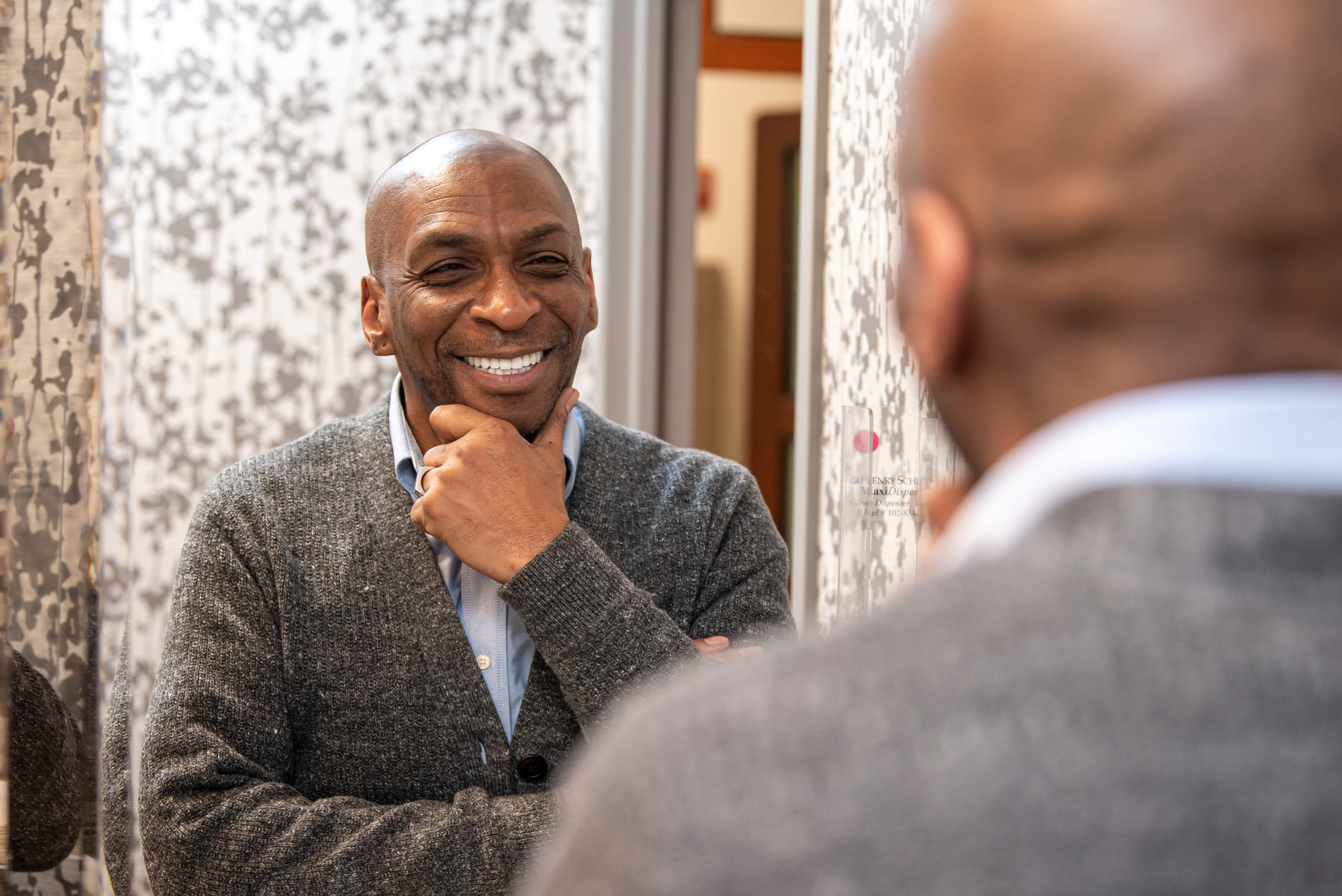 patient looking in mirror after teeth whitening