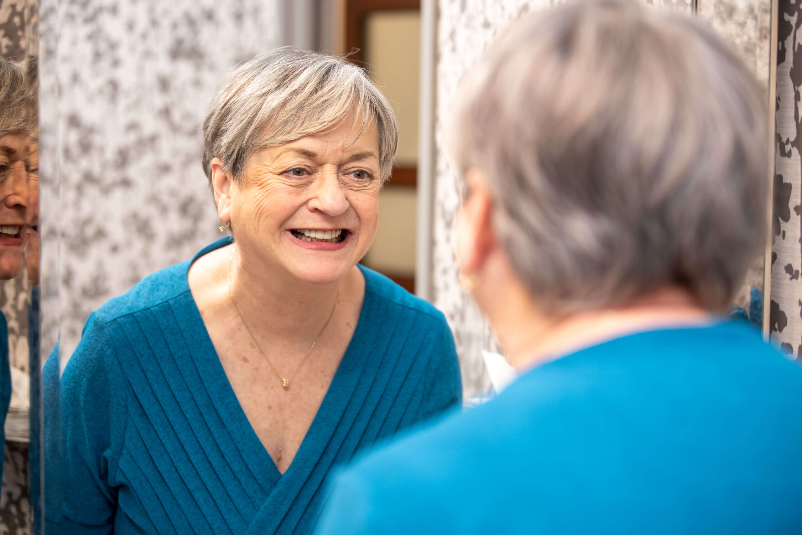 Woman with periodontitis periodontal disease looking in mirror